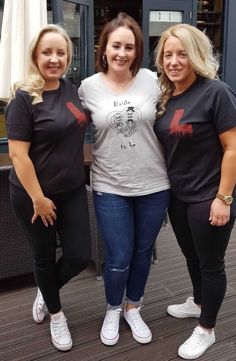 Three women earing personalised t-shirts