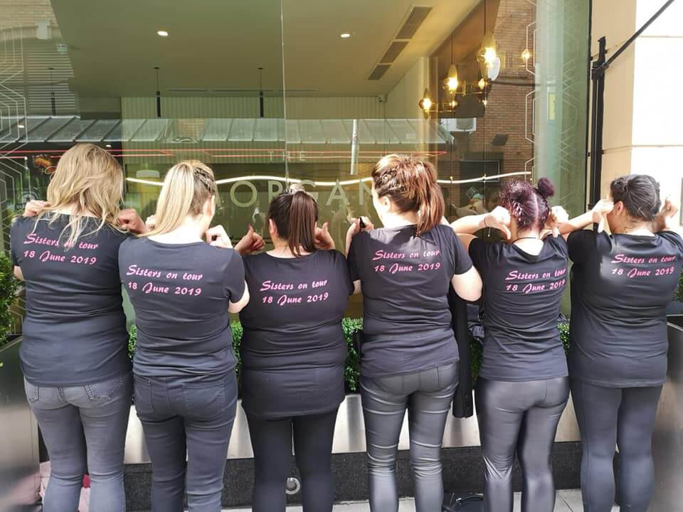 hen party showing off the back of personalised t-shirts